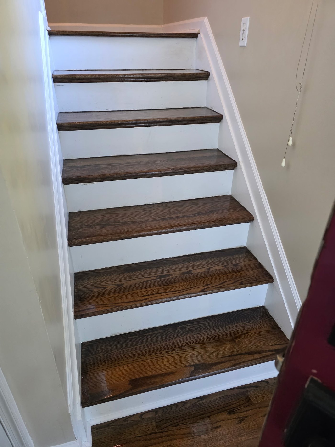 Refinished oak stair treads with white risers in a York, PA home